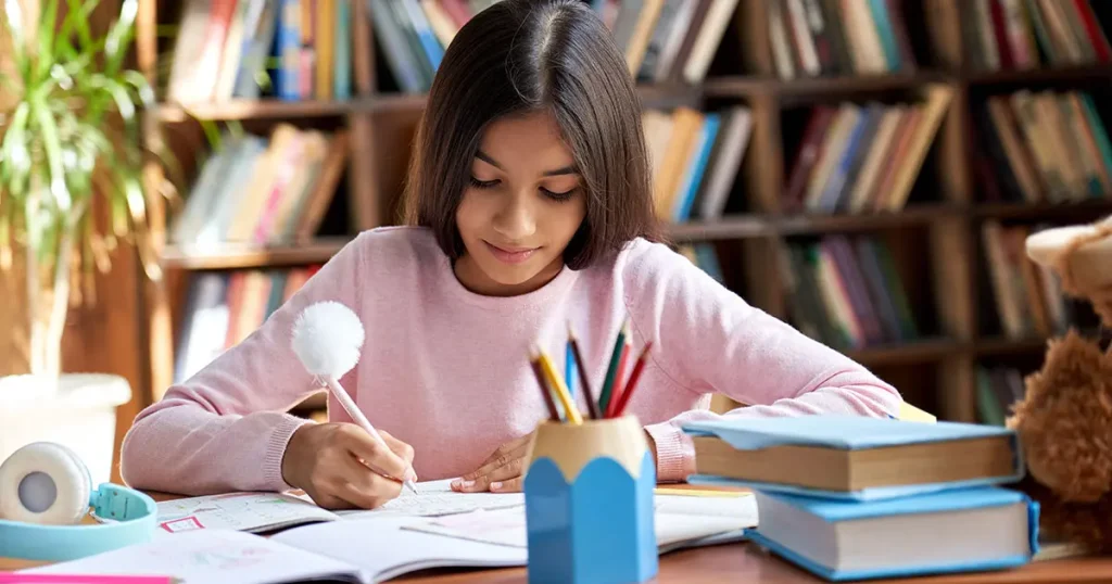 Girl studying in the library for 11 plus